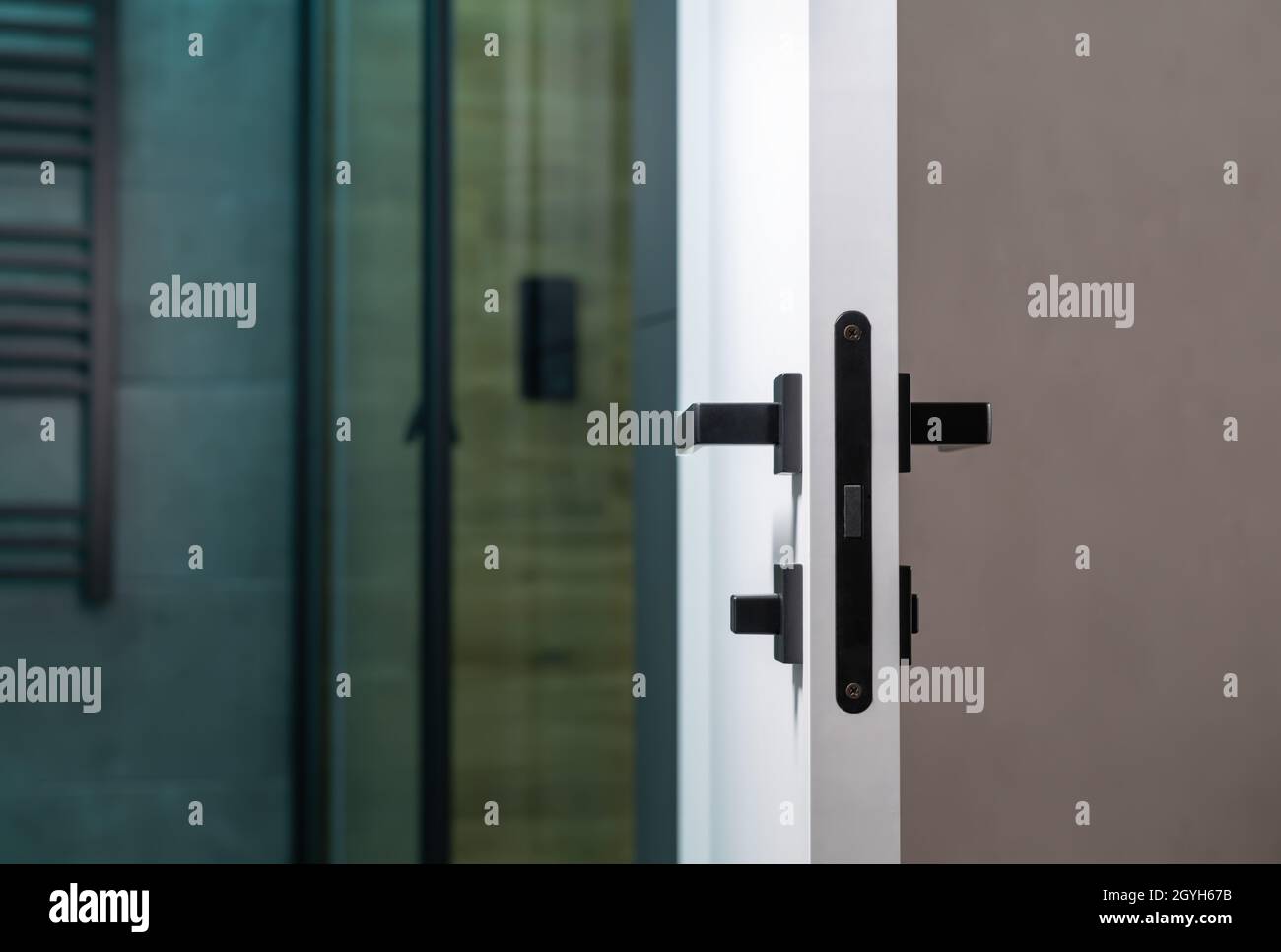 Close focus to the latch and handle mechanism on a bathroom interior door in a privacy and ...