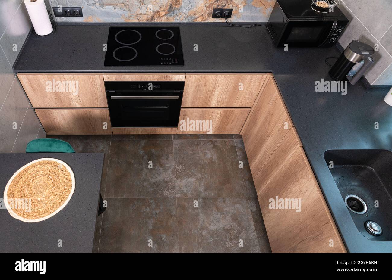 High angle view of a modern compact fitted kitchen with wooden