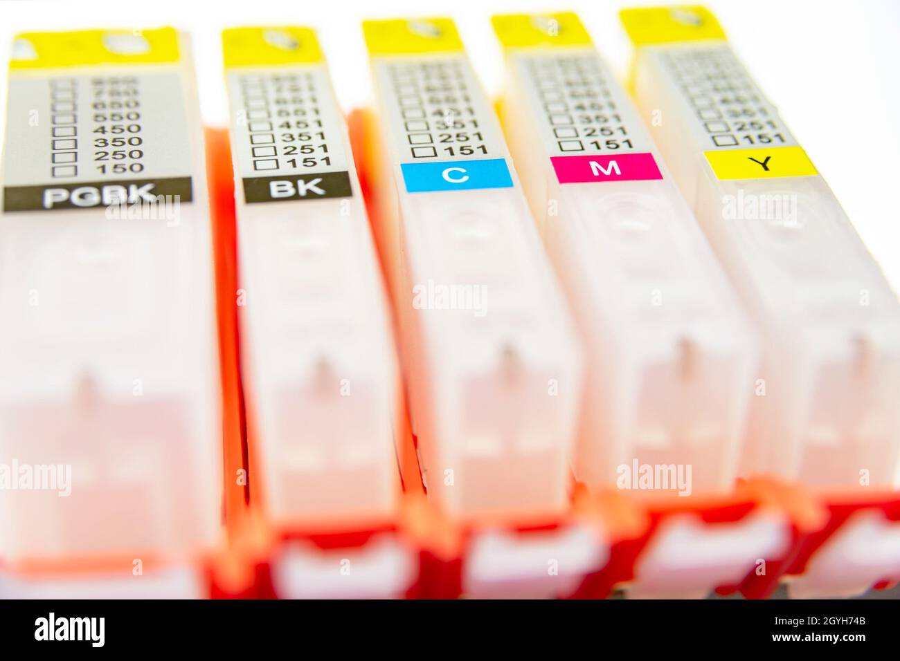 Five refilling cartridges for inkjet printer on a light background