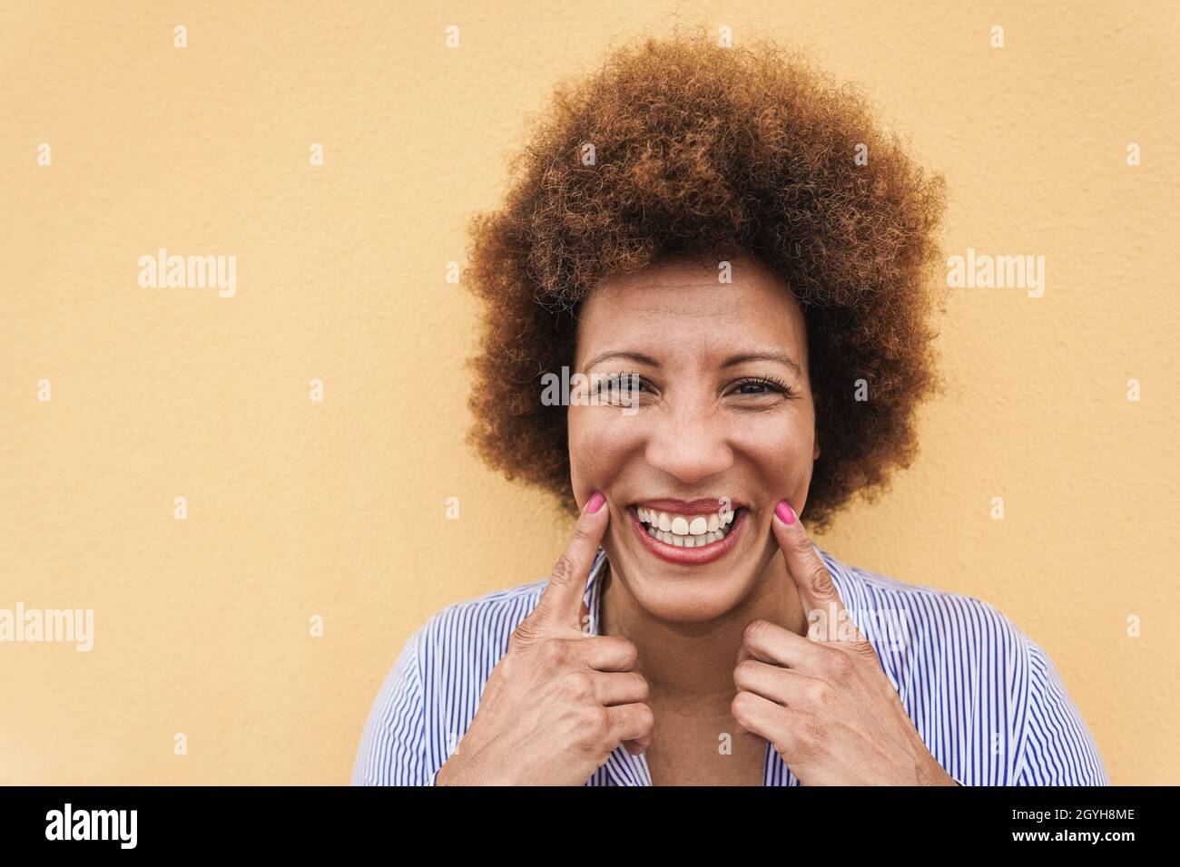 Happy african senior woman smilng on camera outdoor - Focus on face Stock Photo