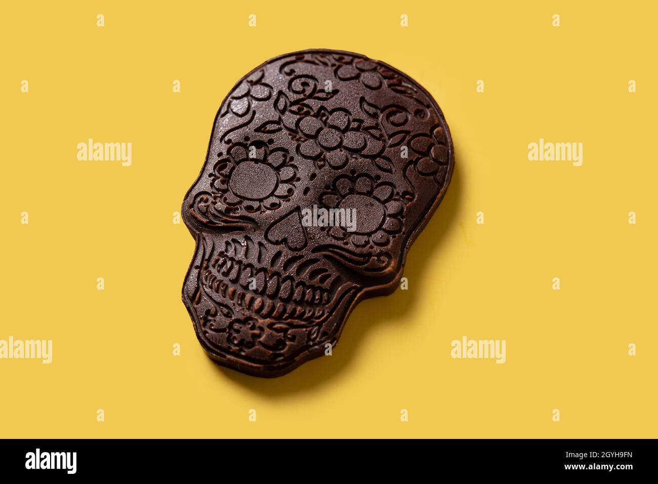 Chocolate Mexican skull on yellow background Stock Photo
