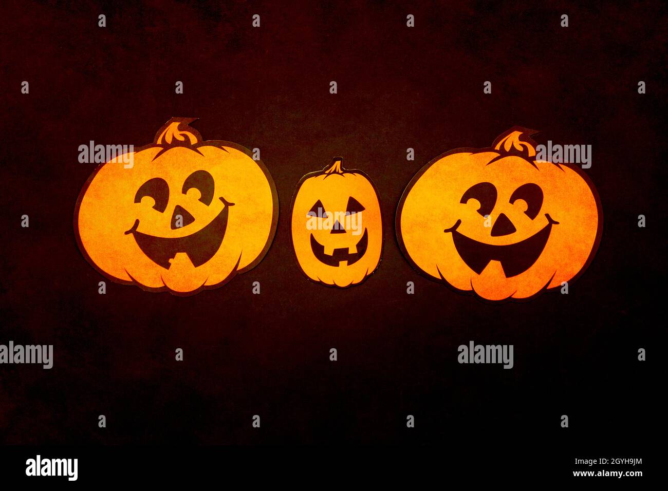 Halloween decor. Orange paper craft pumpkins. on black background Stock Photo - Alamy