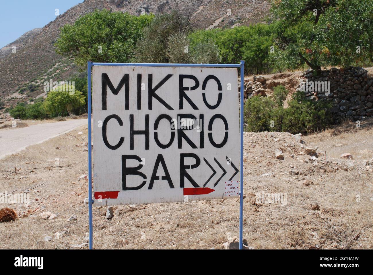 A sign pointing to the music bar in the abandoned village of Mikro Chorio on the Greek island of Tilos. Stock Photo