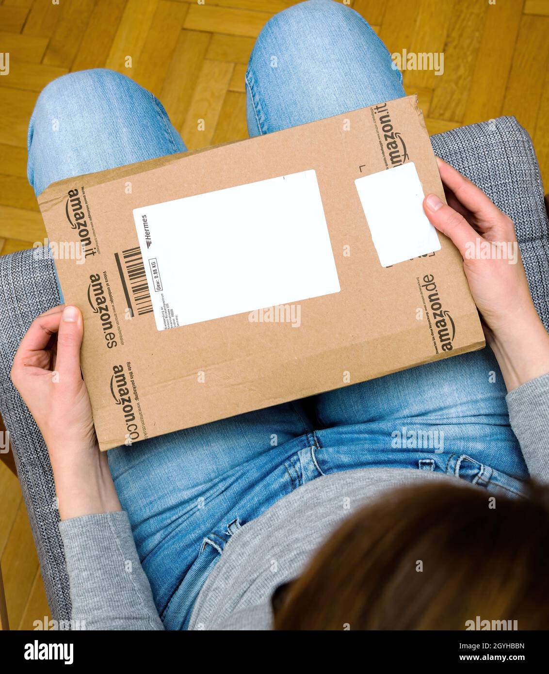 Hermes parcel delivery in woman's hands unboxing in the living room