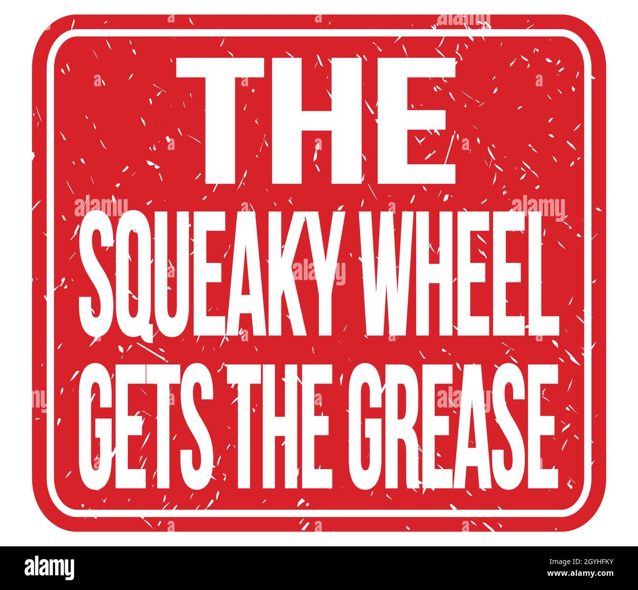 THE SQUEAKY WHEEL GETS THE GREASE, text written on red stamp sign Stock