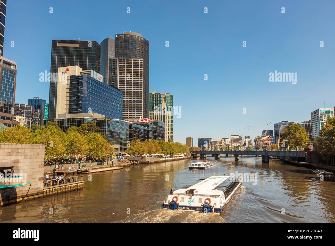 Sightseeing river cruising boats on Yarra River in city centre of Melbourne. Stock Photo