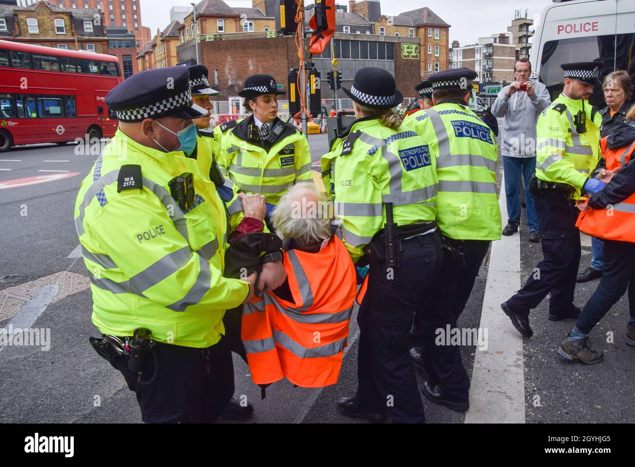 London, United Kingdom. 8th Oct, 2021. Police remove and arrest Insulate Britain protesters who glued themselves to the road at the Old Street roundabout. Insulate Britain protesters are demanding that the government insulates all social housing by 2025, and takes responsibility for ensuring that all homes in the UK are more energy-efficient by 2030, as part of wider climate change and decarbonization targets. Credit: Vuk Valcic/Alamy Live News Stock Photo