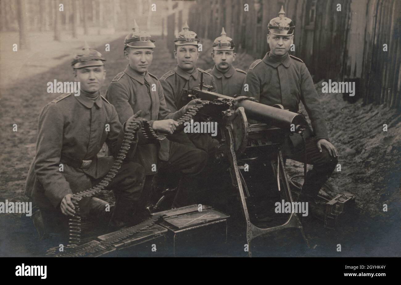 A vintage photo circa 1918 of German soldiers posing with a Maschinengewehr 08 machine gun wearing distinctive spiked Pickelhaube or Pickelhelm helmets Stock Photo