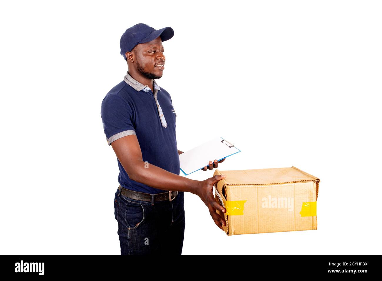 young delivery man in cap standing on white background holding note pad ...