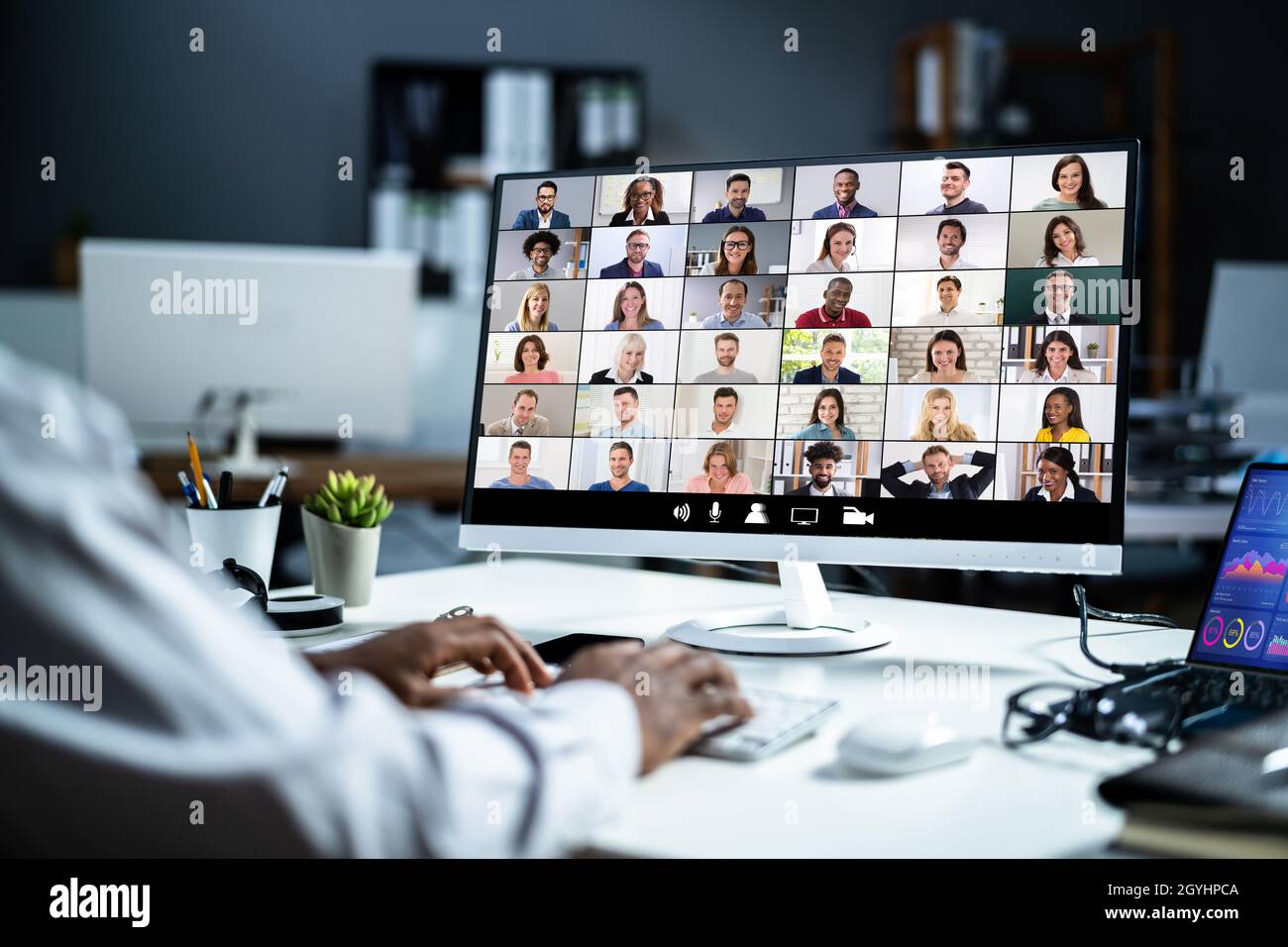 Watching Online Video Conference Meeting In Office Stock Photo