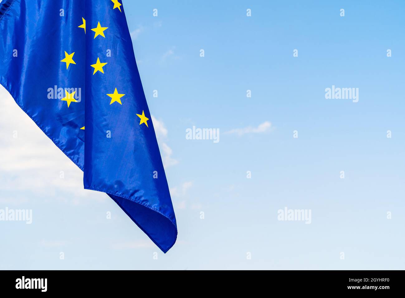 European Union flag against blue sky waving Stock Photo - Alamy