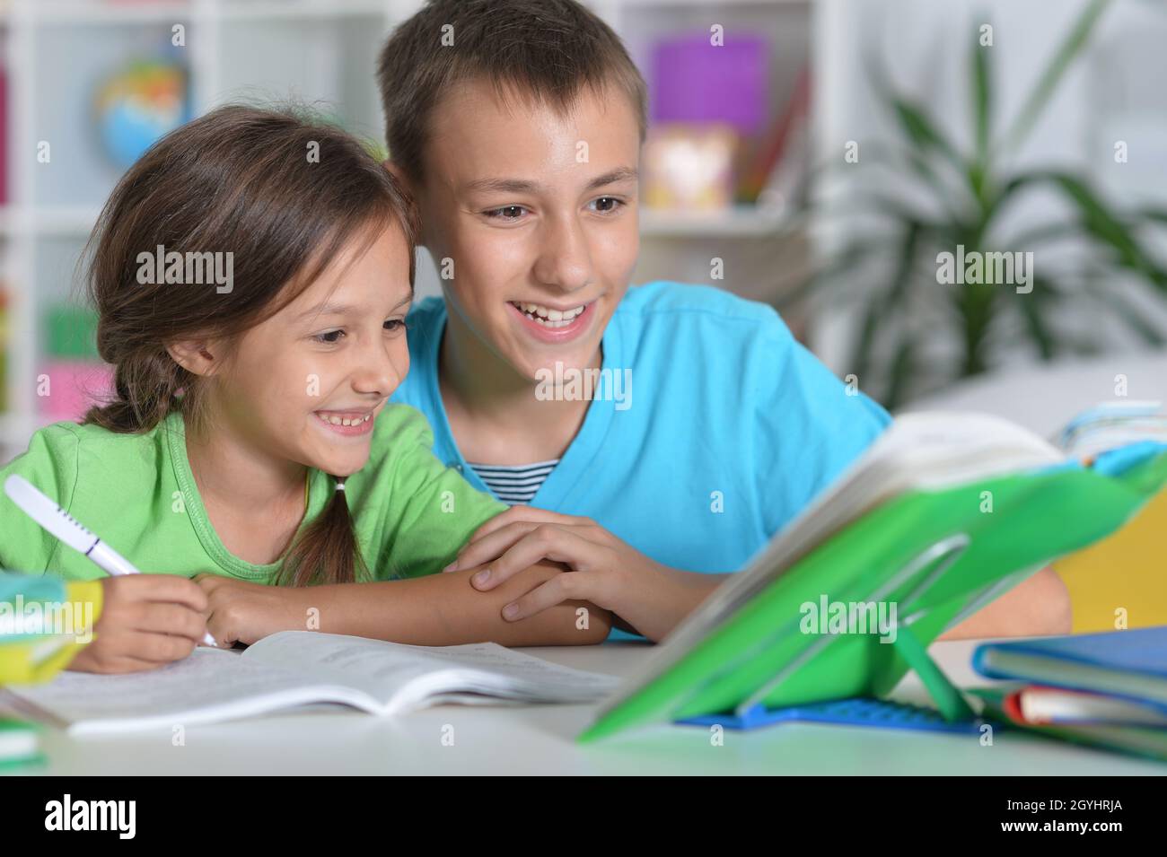 Portrait of brother and sister doing homework together Stock Photo - Alamy