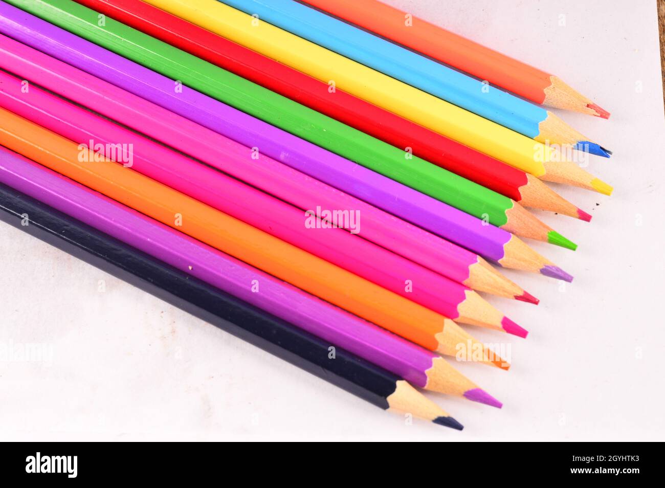 Colored pencils lined up on white background Stock Photo Alamy