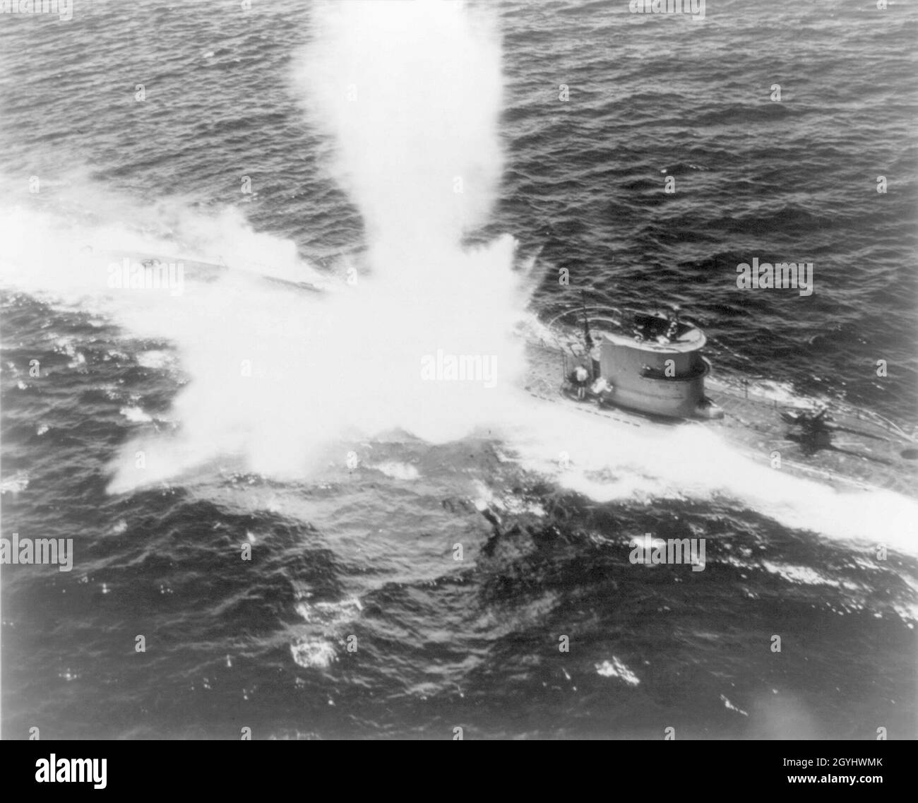 A vintage photo circa 1943 of a German Type VII submarine or U Boat being attacked on the surface by an American naval aircraft in the Atlantic ocean Stock Photo