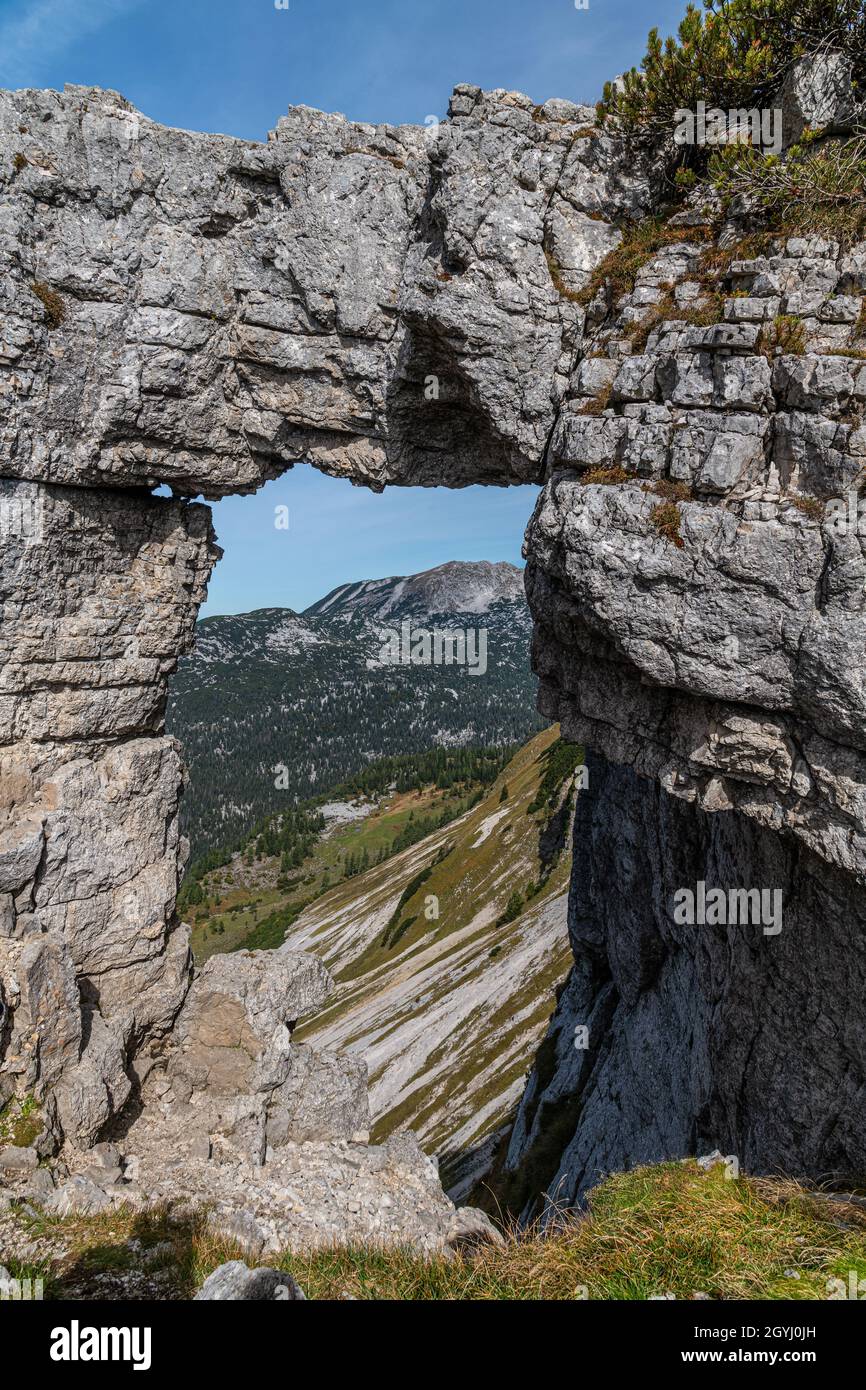 Looking through Loserfenster a natural window in the mountains (Loser,  Salzkammergut, Austria Stock Photo - Alamy