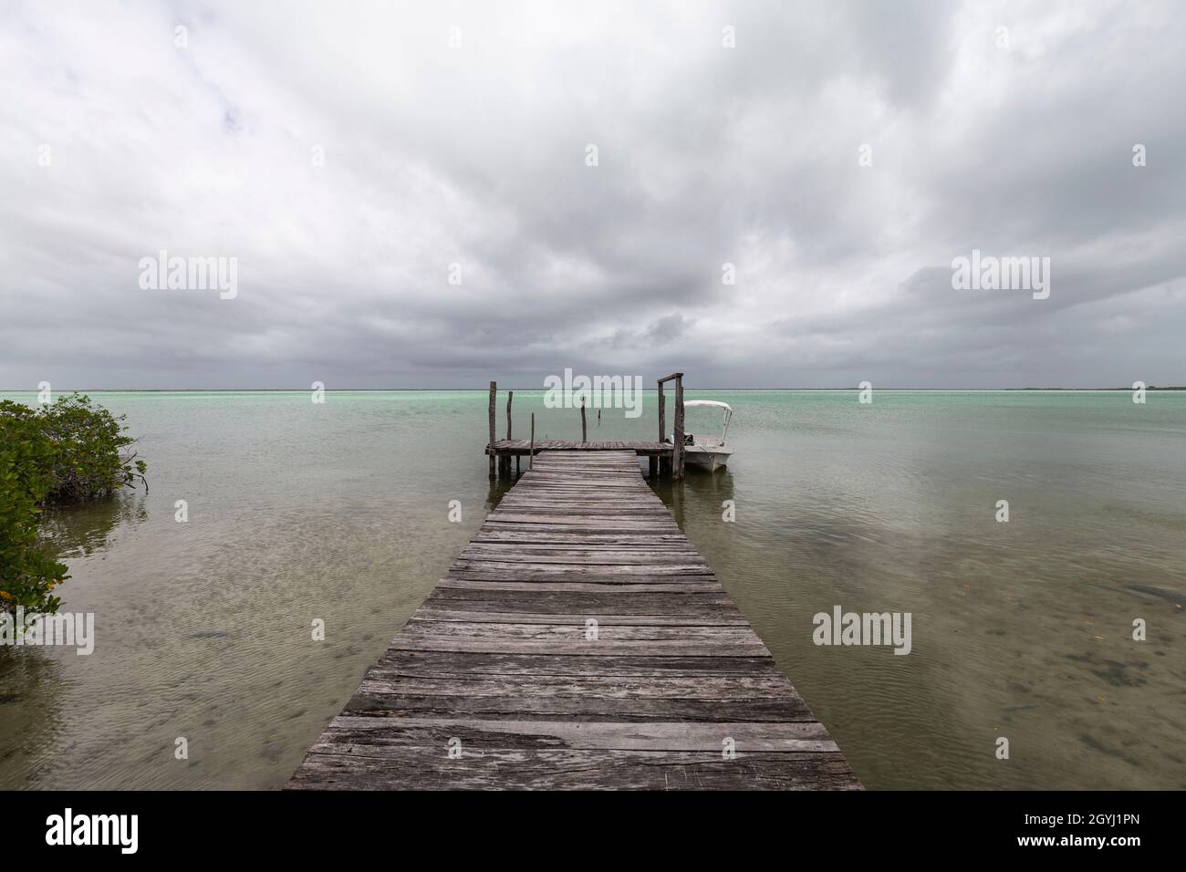 Small fishing boat dock with storm clouds on the Gulf of Mexico. Stock Photo
