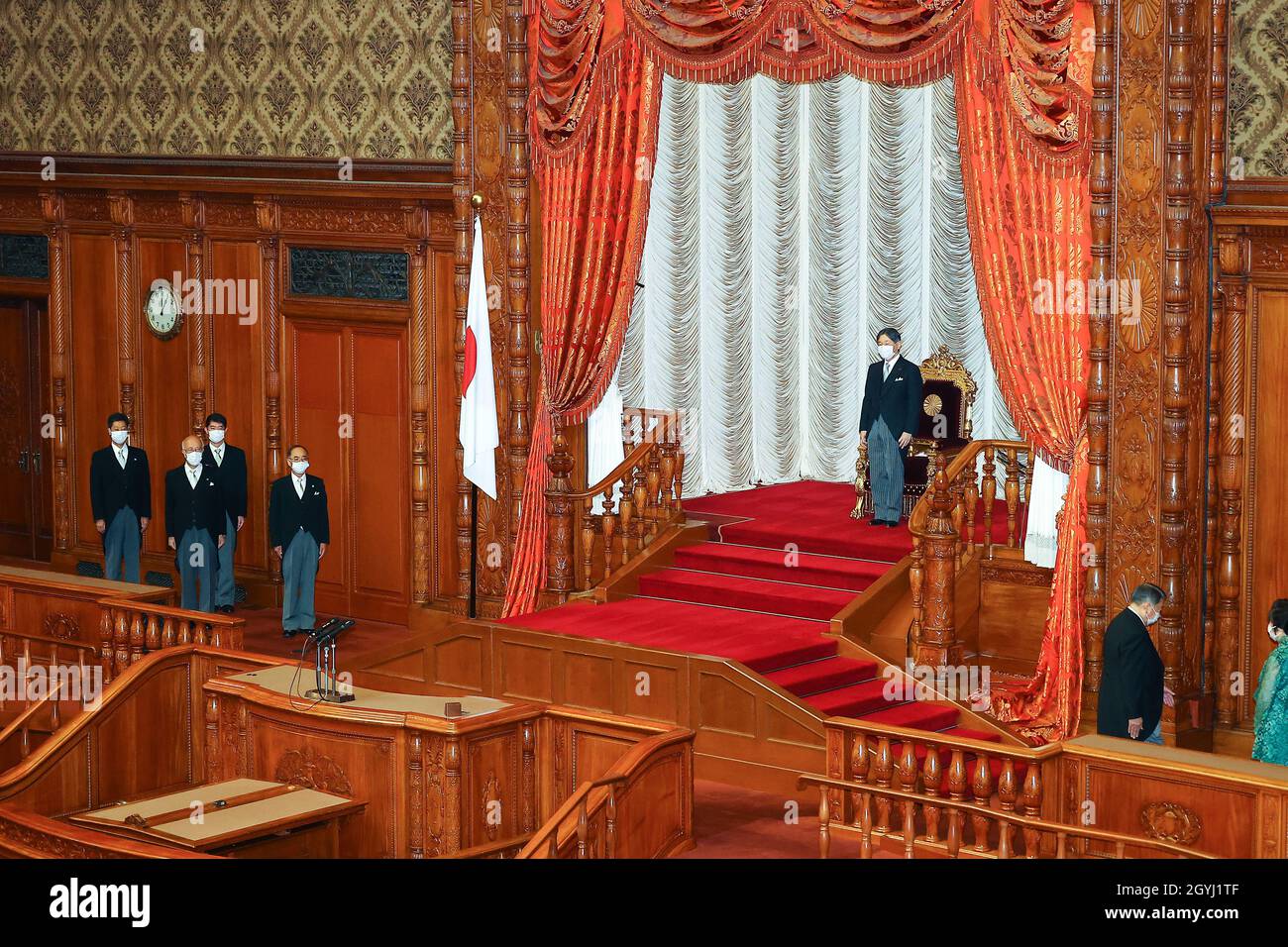 Japan's Emperor Naruhito wearing a face mask, declares the opening of