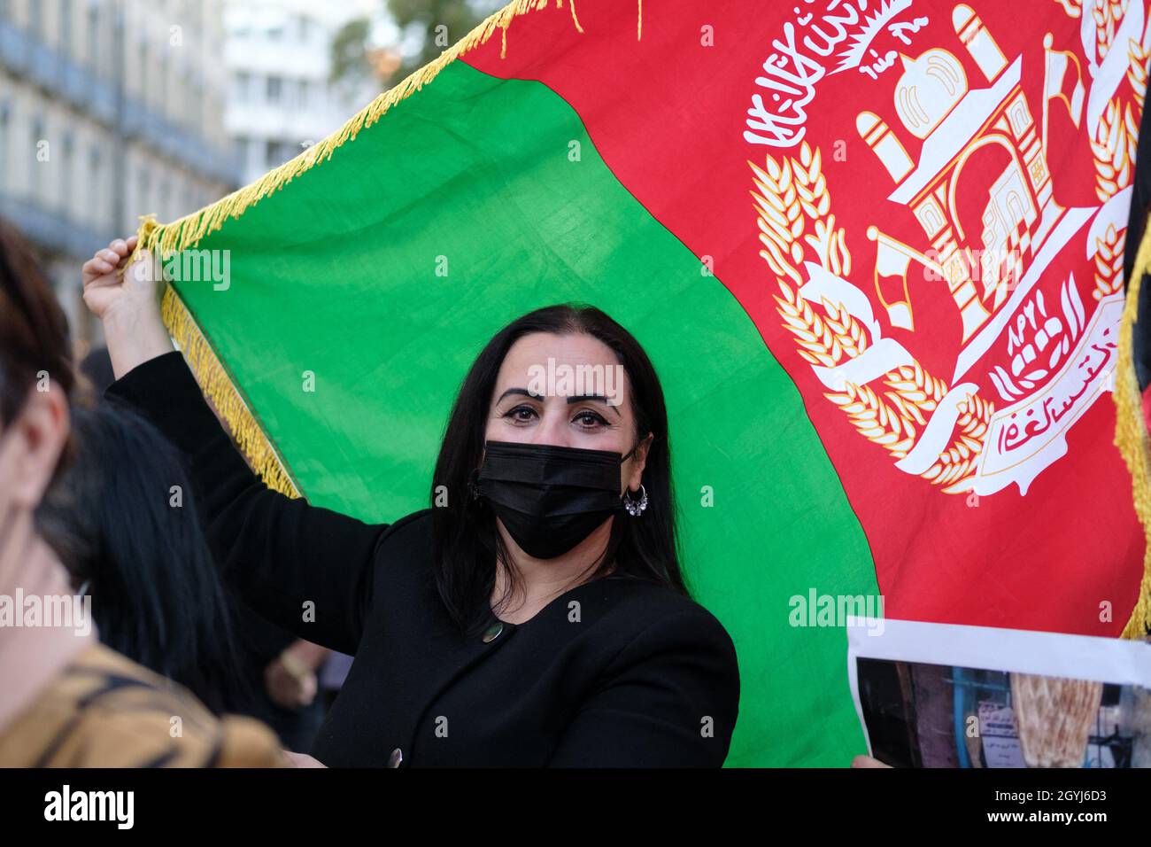 Woman in front of an Afghan flag. In Toulouse (France), a rally took place on October 7, 2021, in support of Afghan women. Repressed during their latest protests in Kabul, women have been permanent targets for the Taliban since they took power last summer. Photo by Patrick Batard/ABACAPRESS.COM Stock Photo