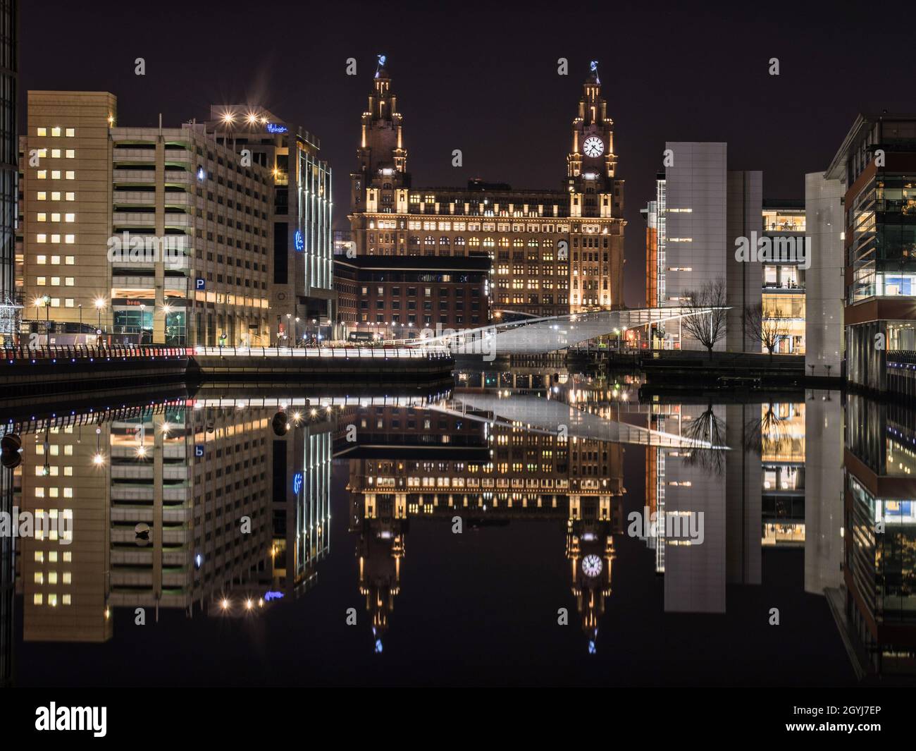 LIVERPOOL, UNITED KINGDOM - Jan 06, 2021: Liverpool Waterfront on a cold winters night with icy glass-like water . Stock Photo