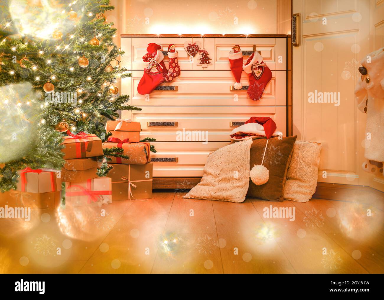 Brightly decorated room at Christmas. Gifts under the Christmas tree and in Santa's boots. Stock Photo