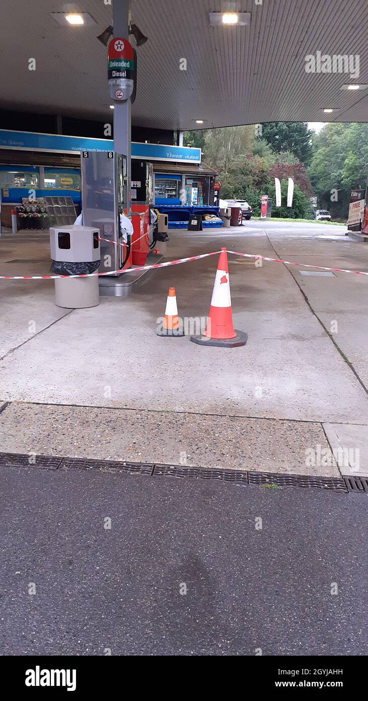 Fuel crisis closed fuel pumps cones and tape barrier, pump hose triggers wrapped in plastic bags, panic buying and shortage of fuel tanker drivers Stock Photo