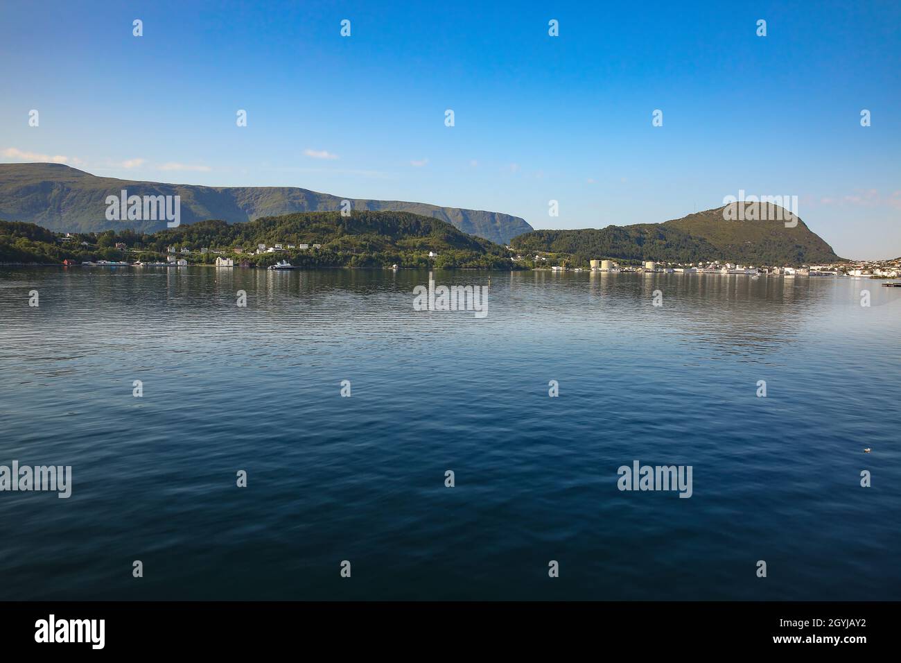 View of the beautiful landscape of the archipelago, islands and fjords with reflections of the land in the ocean, from the port of Alesund, Norway. Stock Photo