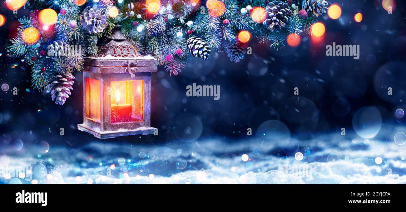 Christmas Lantern In Night With Snow And Fir Branch Stock Photo