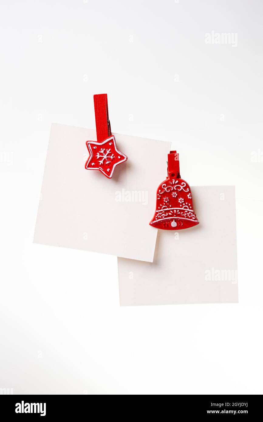 two christmas notes with red clothespins on the background. copy space Stock Photo