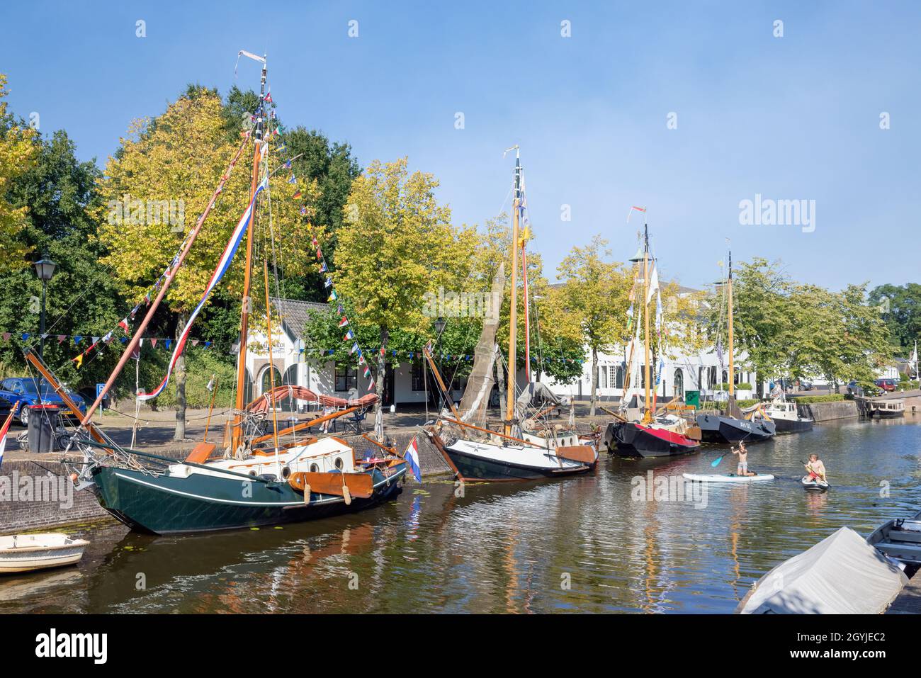 Naarden, The Netherlands - September 08, 2021: Cityscape medieval city Naarden with canal and moored historic sailing ships Stock Photo