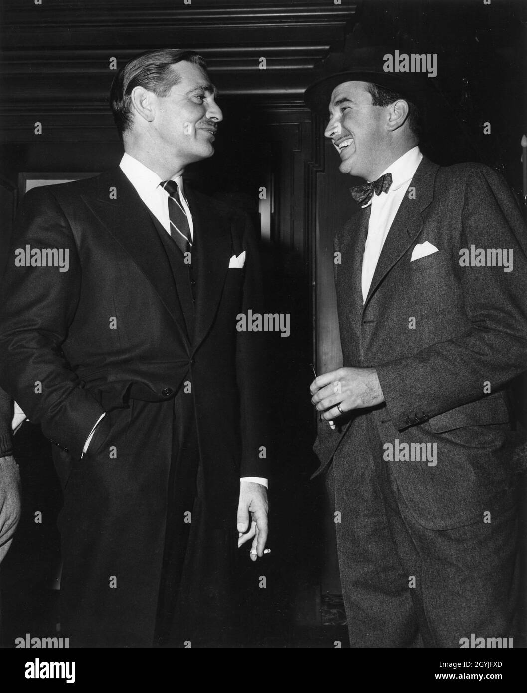 CLARK GABLE with Set Visitor LEE BOWMAN on set candid during filming of