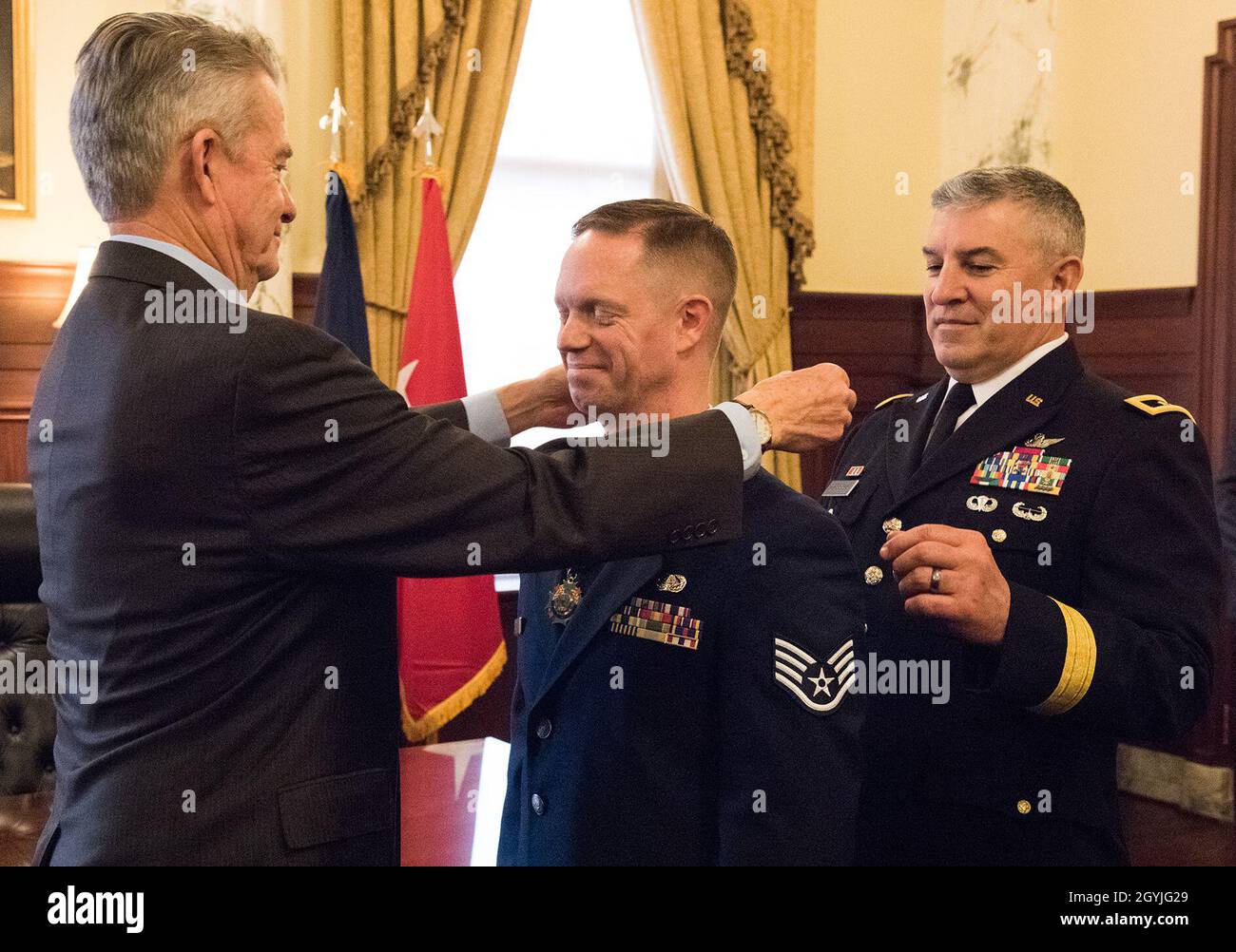 Idaho Governor Brad Little and Maj. Gen. Michael Garshak, adjutant general of Idaho, presented 124th Fighter Wing's Staff Sgt. Kyle Perkins with the Idaho Cross medal at the Idaho State Capitol on Jan. 2, 2020 for his significant act of heroism on the evening of June 14, 2019. Perkins quickly responded to a man sitting next to him in distress. Perkins and his wife, Allia, assessed and secured the scene and performed CPR until the paramedics arrived. His actions saved the man's life. The Idaho Cross is the highest state award presented to a military member or civilian employee of the Idaho Mili Stock Photo