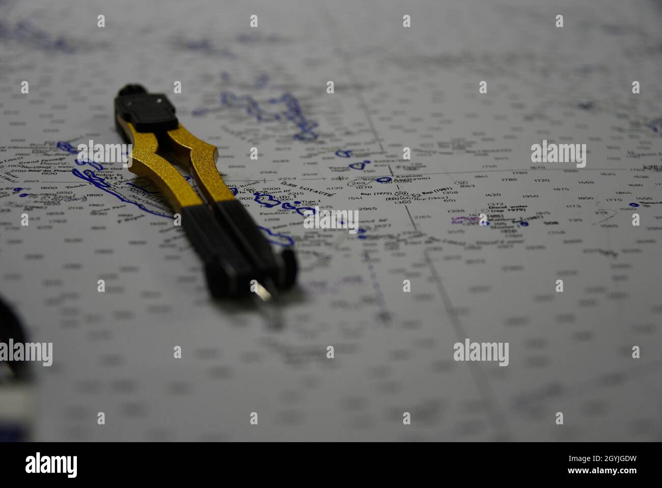 A compass sits atop a nautical chart Jan. 3, 2020, aboard the U.S