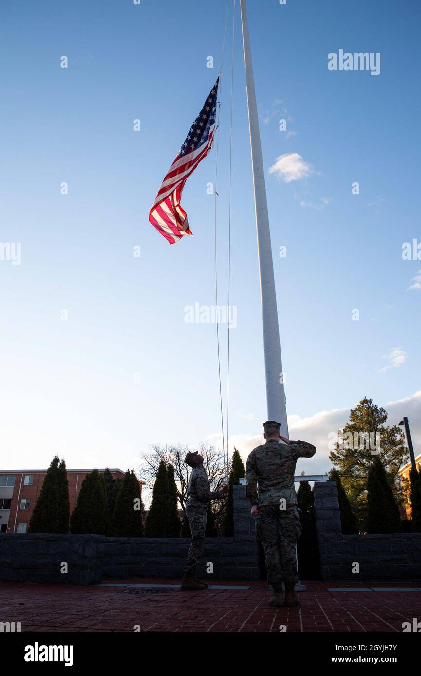 U.S. Marines with Headquarters and Service Battalion, Henderson Hall, Headquarters Marine Corps, raise the national ensign to half-mast in honor of Gen. Paul X. Kelley, the 28th Commandant of the Marine Corps' passing, at Joint Base Ft. Myer-Henderson Hall, Arlington, Va., Jan. 5, 2020. Colors can be flown by the order of the President upon the death of principal figures of the United States Government and the Governor of a State, territory, or possession, as a mark of respect to their memory. (U.S. Marine Corps photo by Lance Cpl. Morgan L. R. Burgess) Stock Photo