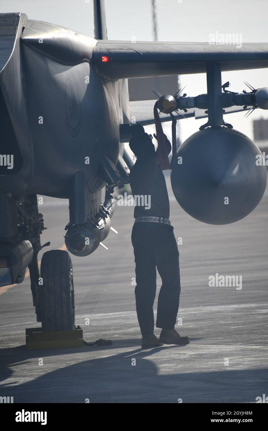 U.S. Air Force Staff Sgt. Zackary Suttles, a crew chief with the 378th Expeditionary Maintenance Squadron, conducts a post landing inspection on an F-15E Strike Eagle at Prince Sultan Air Base, Kingdom of Saudi Arabia, Jan. 4, 2020. The F-15E’s ability to conduct air-to-air and air-to-ground operations ensures U.S. Air Forces Central Command's ability to defend against state and non-state actors throughout the region. (U.S. Air Force photo by Senior Airman Giovanni Sims) Stock Photo