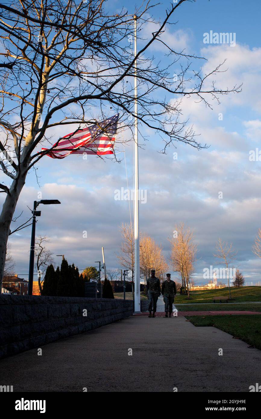 U.S. Marines with Headquarters and Service Battalion, Henderson Hall, Headquarters Marine Corps, raise the national ensign to half-mast in honor of Gen. Paul X. Kelley, the 28th Commandant of the Marine Corps' passing, at Joint Base Ft. Myer-Henderson Hall, Arlington, Va., Jan. 5, 2020. Colors can be flown by the order of the President upon the death of principal figures of the United States Government and the Governor of a State, territory, or possession, as a mark of respect to their memory. (U.S. Marine Corps photo by Lance Cpl. Morgan L. R. Burgess) Stock Photo