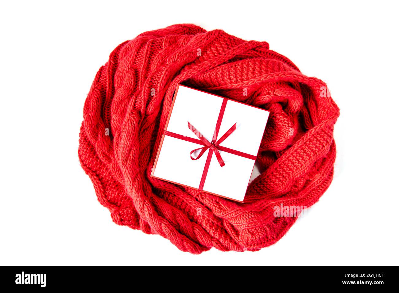 Gift white box with red ribbon and bow isolated on white. View from ...