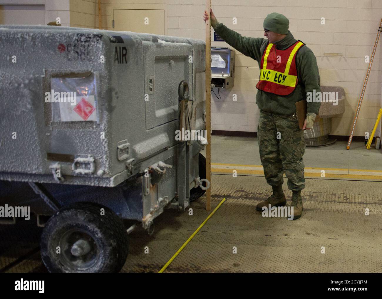 A U.S. Airman assigned to the 673d Logistics Readiness Group measures ...