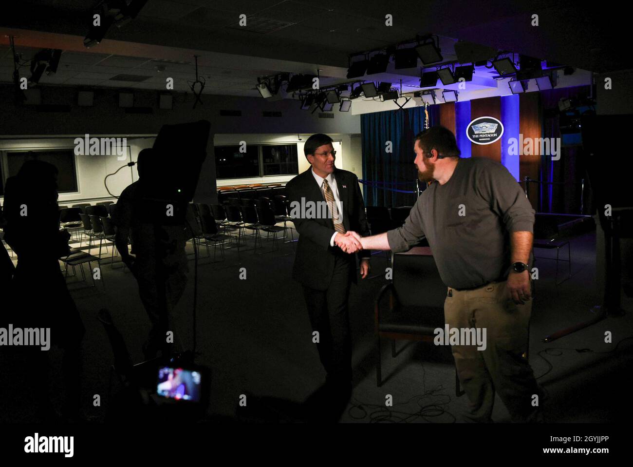 Defense Secretary Mark T. Esper shakes hands with staff as he finishes a video interview with CNN International's Christiane Amanpour, at the Pentagon, Washington, D.C., Jan. 7, 2020. (DoD photo by Navy Petty Officer 2nd Class James K. Lee) Stock Photo