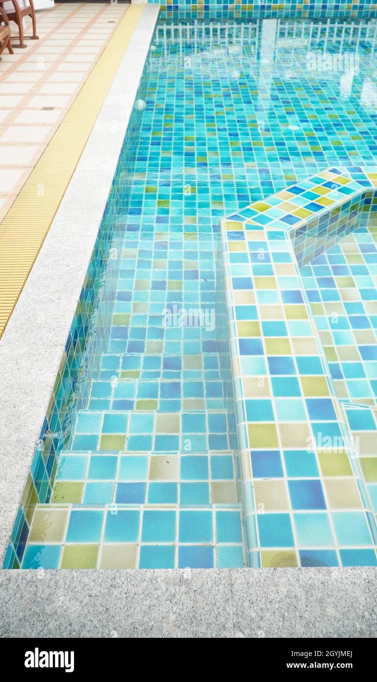 Stair way to step down into swimming pool with clear and clean water