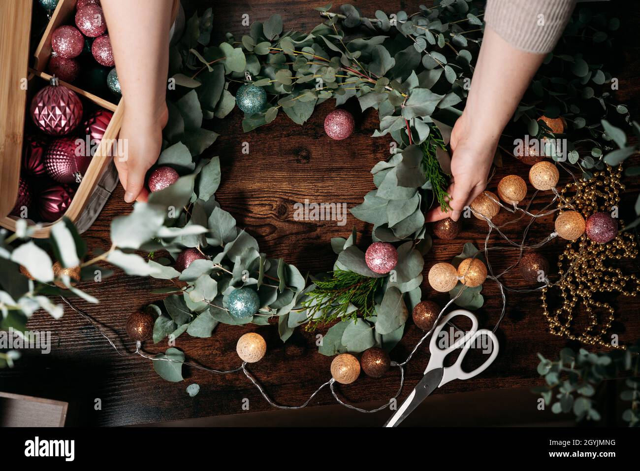 Top view of handmade christmas wreath on dark table Stock Photo