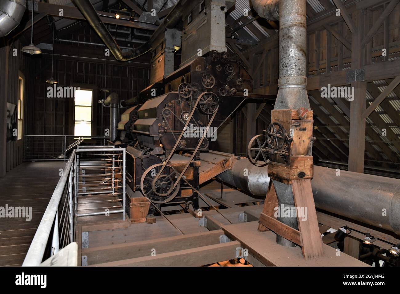 The engine, belts, pulleys, gears and equipment to operate a pre World War II cotton gin. Stock Photo