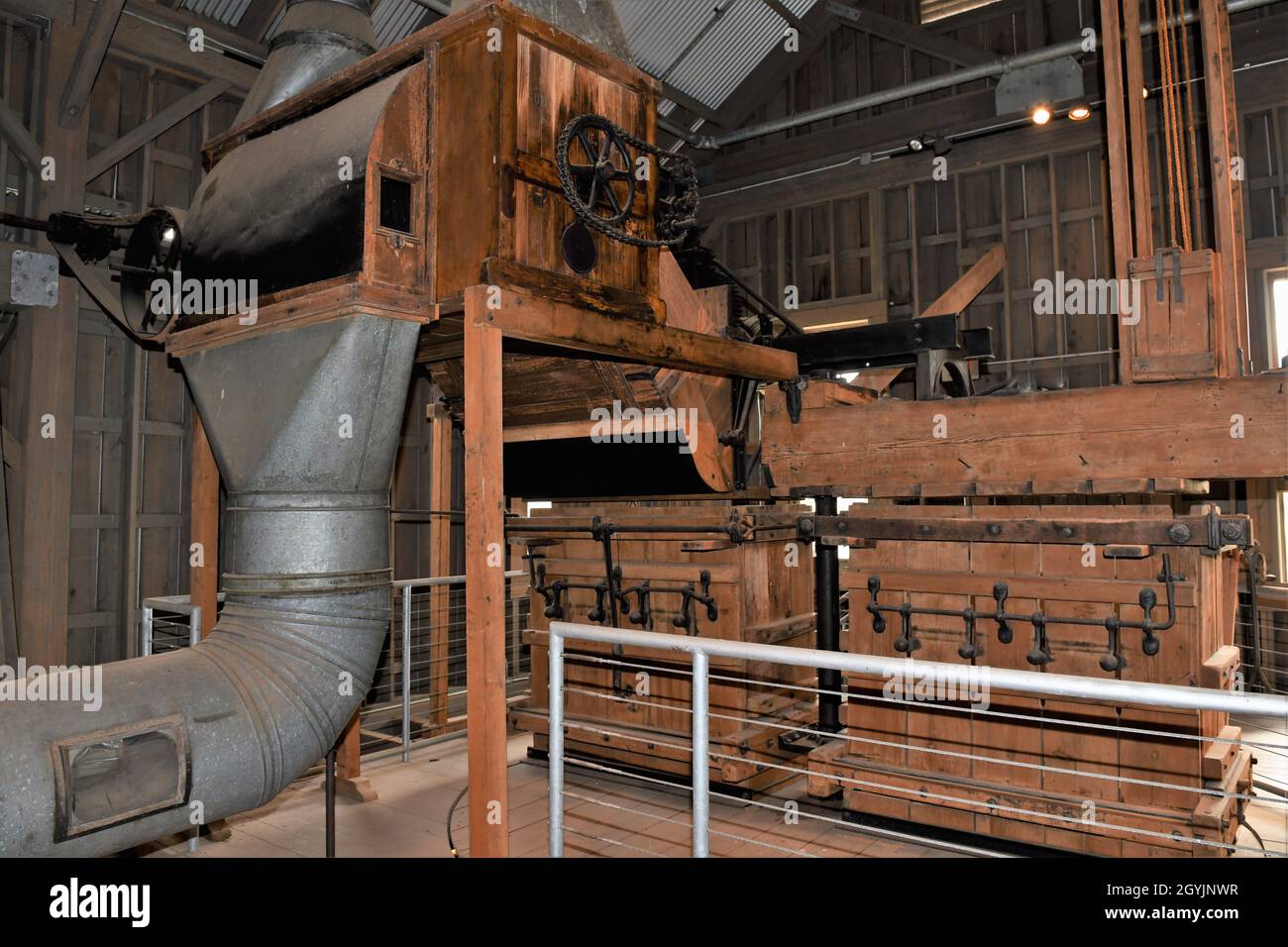 The engine, belts, pulleys, gears and equipment to operate a pre World War II cotton gin. Stock Photo