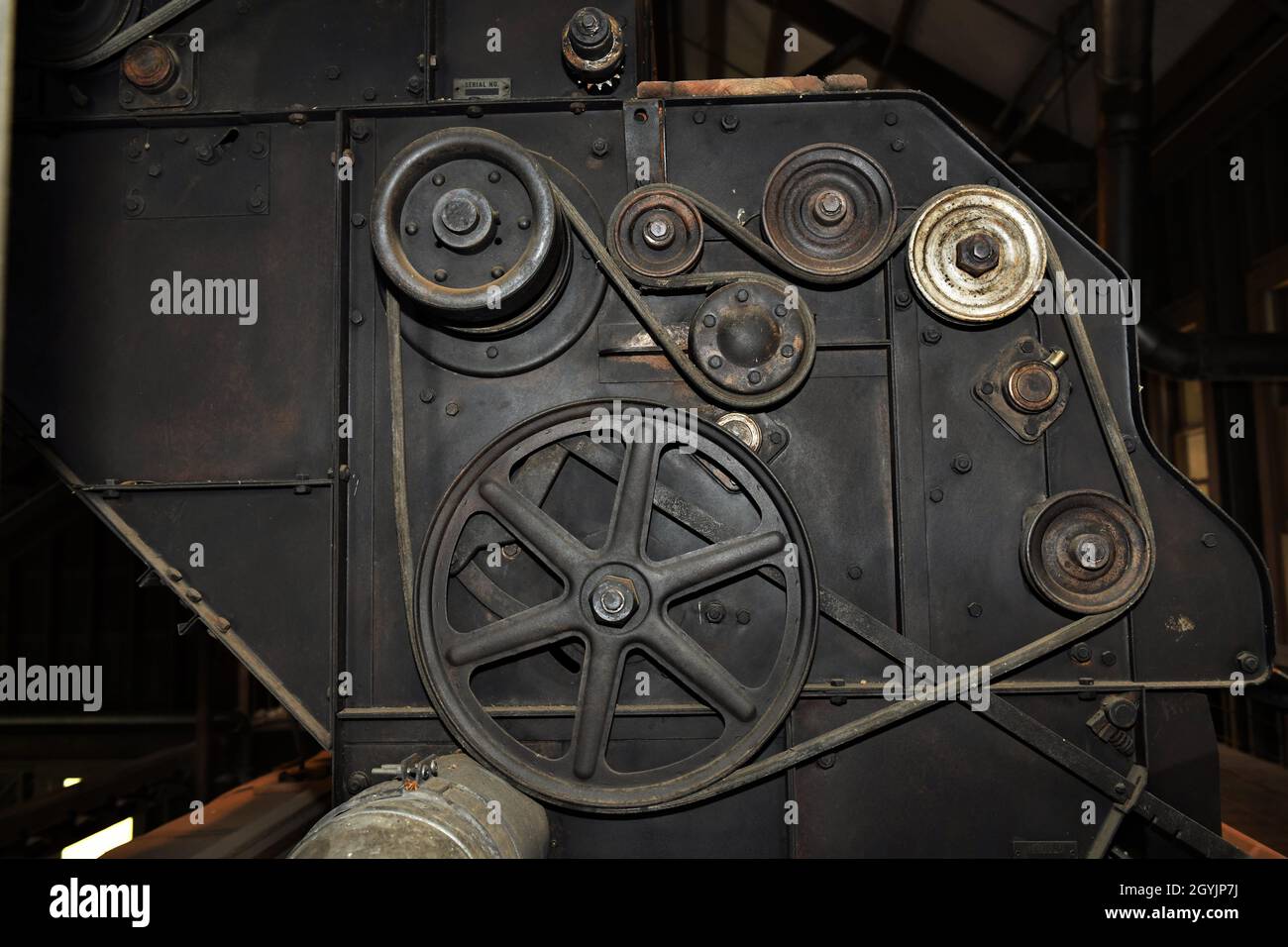 The engine, belts, pulleys, gears and equipment to operate a pre World War II cotton gin. Stock Photo