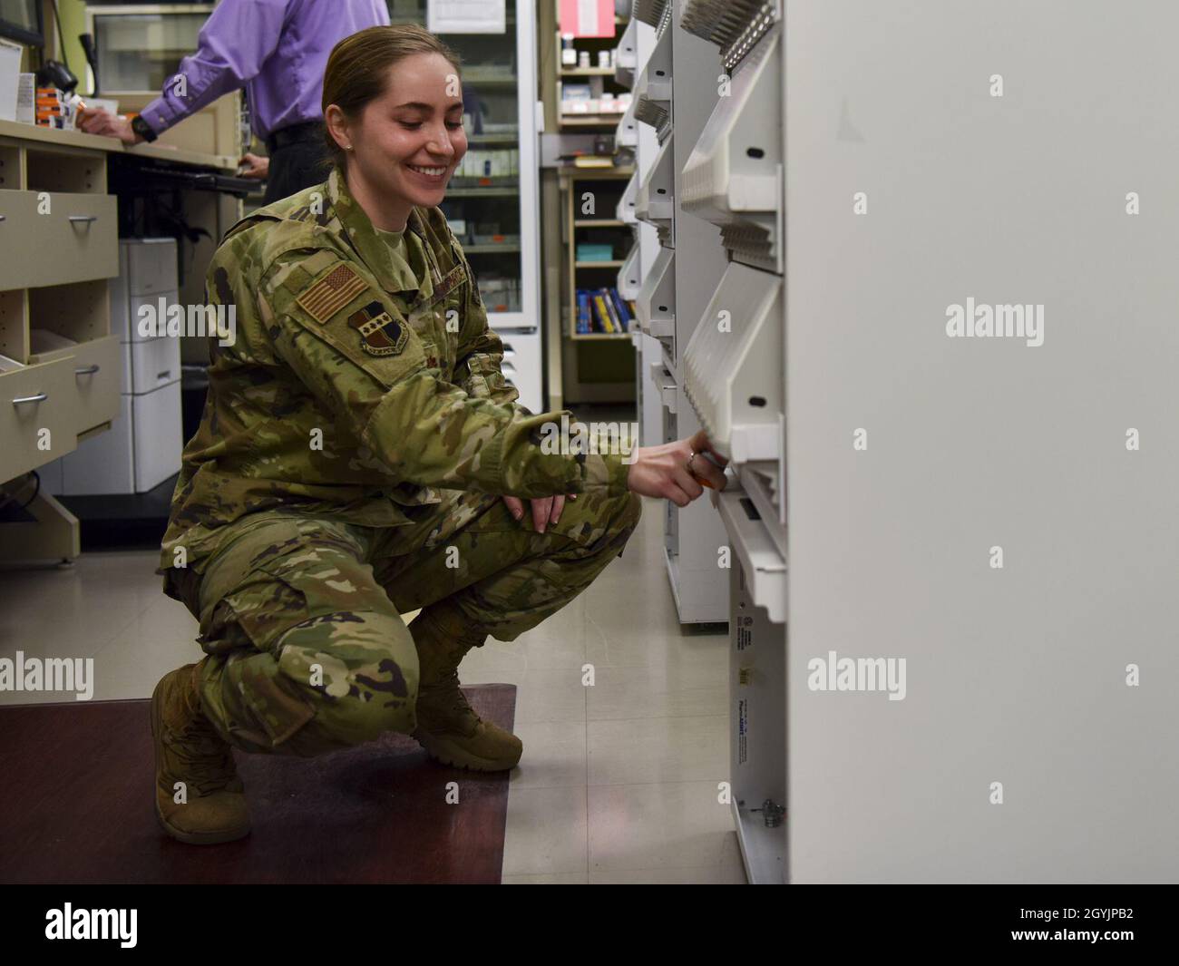Maj. Andrea Russell, 9th Medical Support Squadron pharmacy element chief, fills up a bottle with