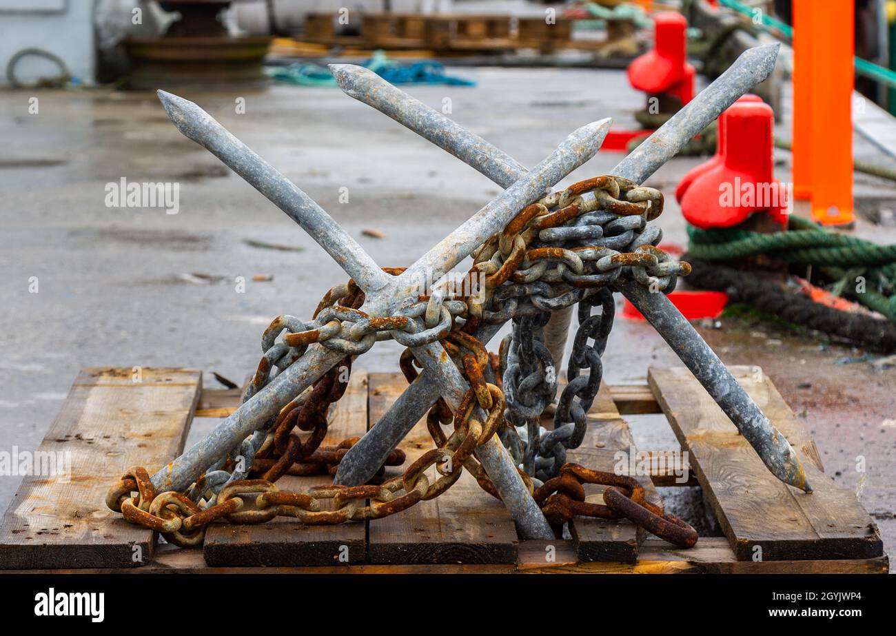 Galvanised Four pronged Fixed Grapnel Anchors Stock Photo
