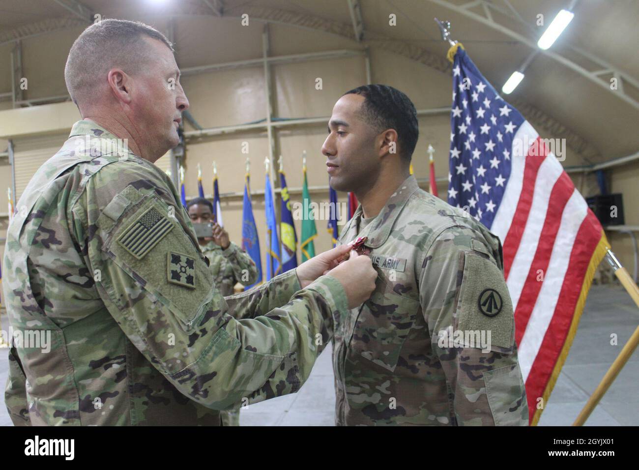 Lt. Col. Billy J. Tucker, 840th Transportation Battalion commander, pins the Meritorious Service Medal on Capt. Michael D. McDonald, 840th Transportation Battalion, during a ceremony at Camp Arijfan, Kuwait, Jan. 10, 2020. (U.S. Army photo by Claudia LaMantia) Stock Photo