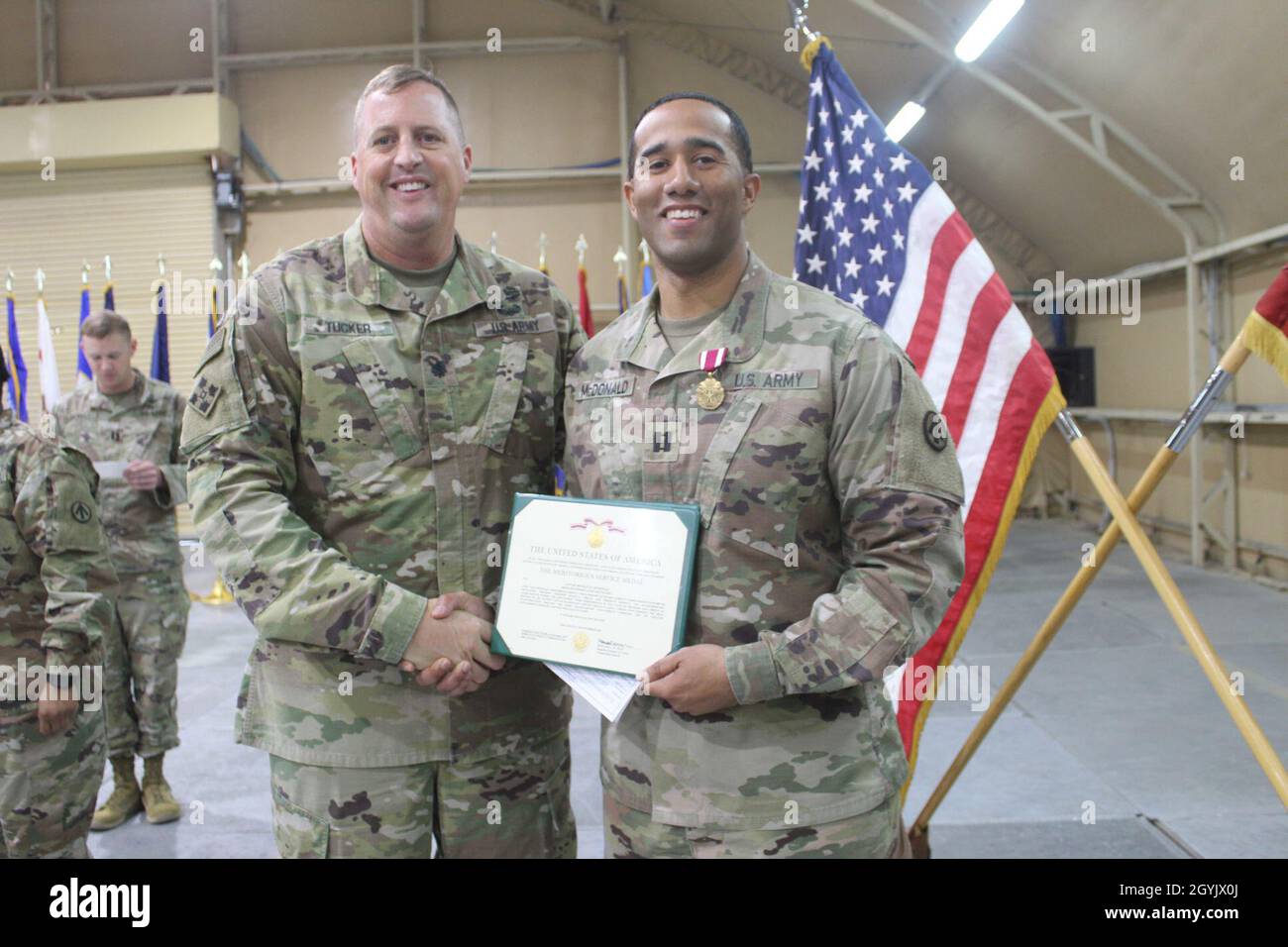 Lt. Col. Billy J. Tucker, 840th Transportation Battalion commander, poses with Capt. Michael D. McDonald following a Meritorious Service Medal ceremony at Camp Arijfan, Kuwait, Jan. 10, 2020. (U.S. Army photo by Claudia LaMantia) Stock Photo