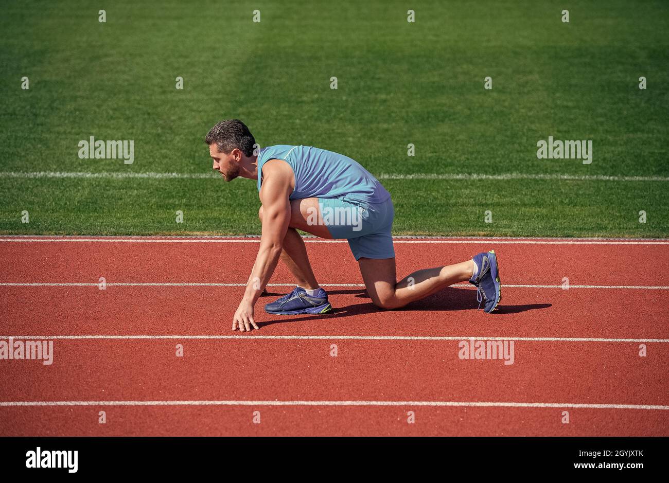 Runner ready to go. Athlete runner prepare to race at stadium. Running