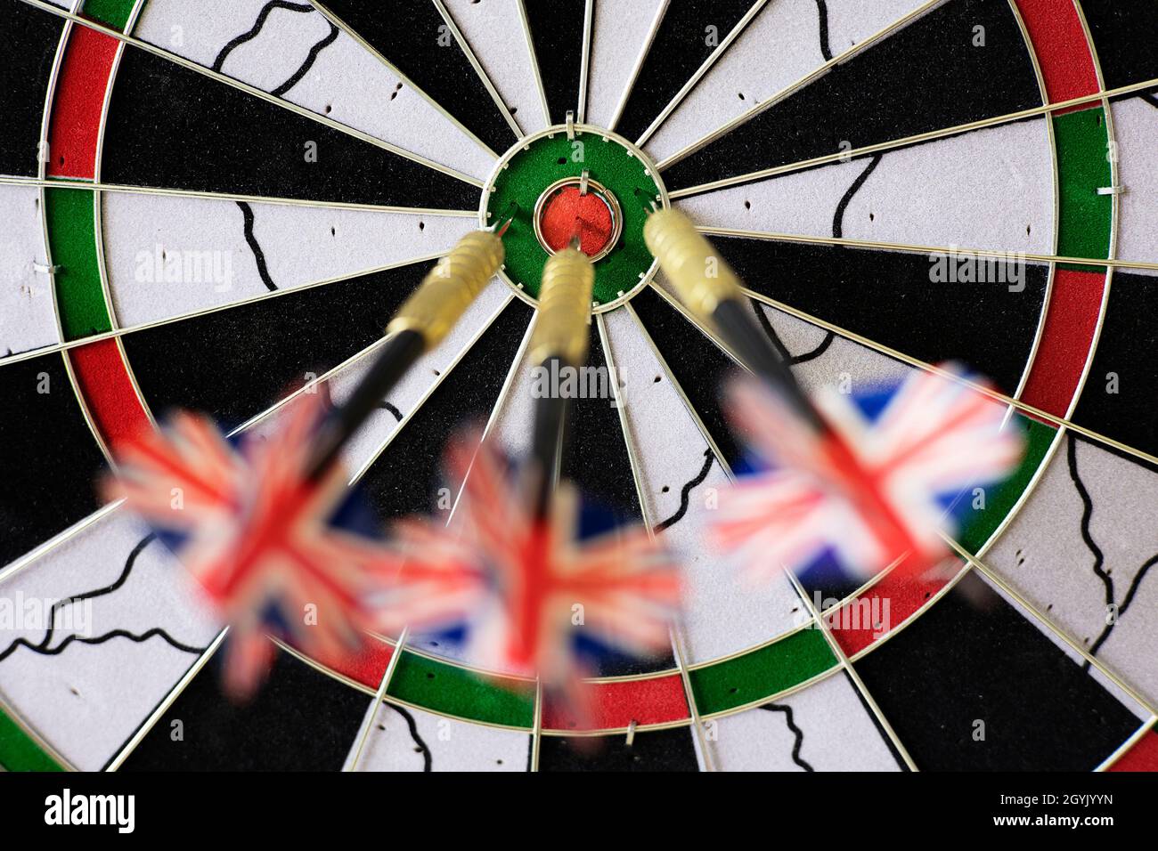 Three steel tip darts in a dart board. Stock Photo