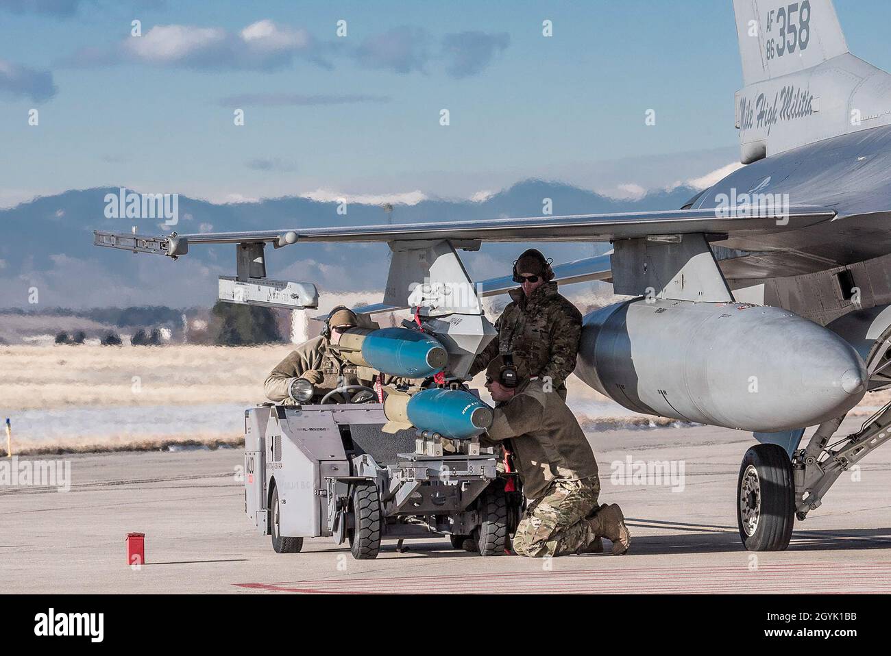 Colorado Air National Guard Airmen from the 140th Maintenance Group, load  bombs onto an F-16 Fighting Falcon during an integrated combat turn (ICT)  training exercise, Buckley Air Force Base, Colo., Jan. 12,